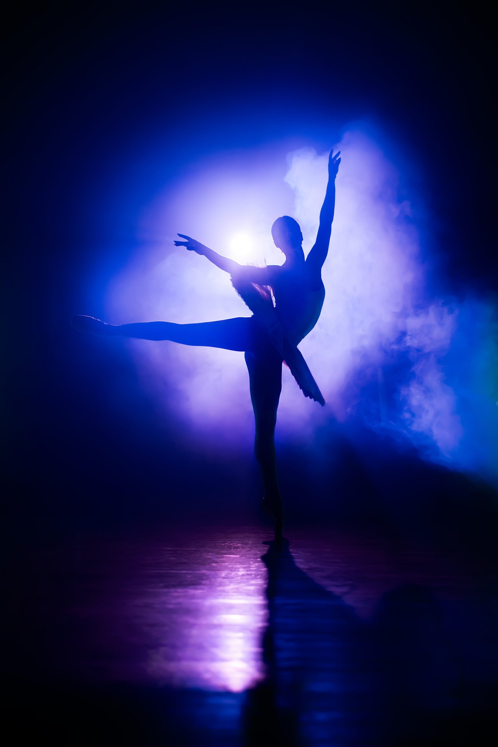 silhouette of ballerina in studio with violet neon colorful light. young woman dancing in classic tutu dress. gracefulness and tenderness in every movement.